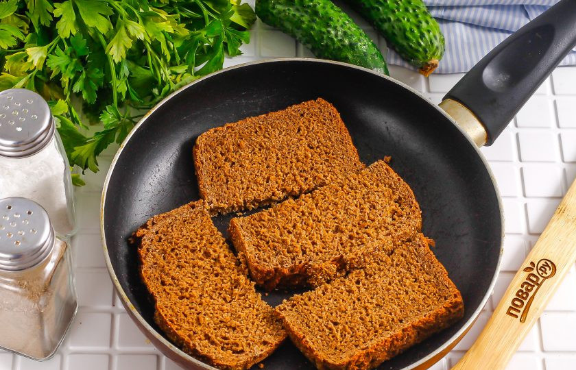 1. Этап. Тосты с селедкой: Прогрейте масло на сковороде. Хлеб нарежьте порционными ломтиками и обжарьте примерно по минуте с каждой стороны. Остудите тосты в течение 5-7 минут.