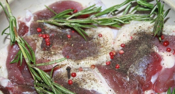 1. Этап. Утиные ножки в духовке: Когда подошло отведённое время, мясо нужно очень хорошо вымыть, чтобы на нём не осталось соли. Теперь возьмите форму для запекания, смажьте её маслом, выложите туда мясо. Добавьте розовый и чёрный перец, розмарин и по вкусу немного гвоздики.