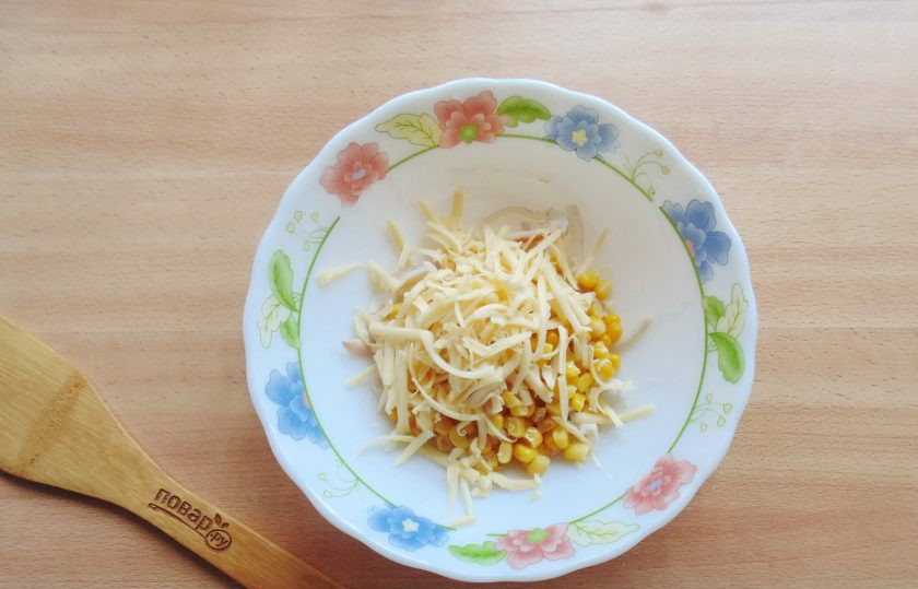 1. Этап. Салат с кальмарами и перепелиными яйцами: Любой твердый сыр натрите на терке, выложите в салат.