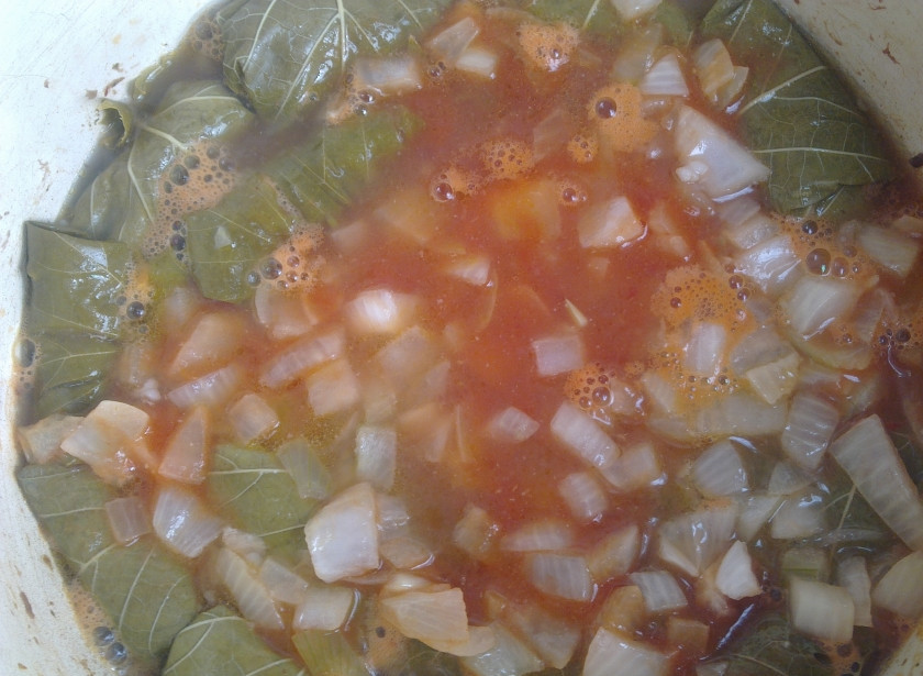 1. Этап. Голубцы из виноградных листьев: Добавьте зажарку к голубцам, посолите и поперчите по вкусу. Добавьте приправ, по необходимости долейте воды. Тушите до готовности.