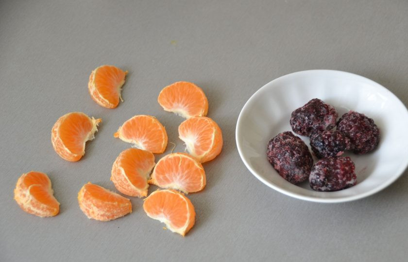 1. Этап. Прозрачное желе: Подготовьте мандарин, разберите его на дольки. Разморозьте несколько ягод ежевики.