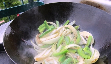 1. Этап. Мясо в воке: Очищенные и нарезанные лук и перец быстро обжариваем в воке.