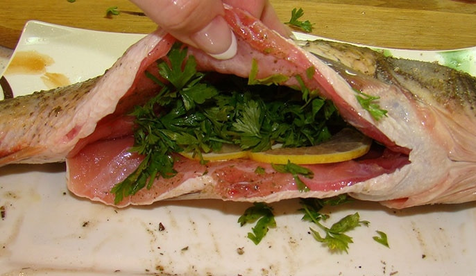 1. Этап. Рыба в пароварке: 2. Рыбу чистим от чешуи, разрезаем брюхо и вынимаем внутренности. Тщательно моем и вытираем рыбу. С внешней стороны натираем рыбу солью и специями, а внутрь выкладываем ломтики лимона и зелень, добавляем немного специй. Сбрызгиваем оливковым маслом.