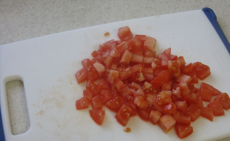 1. Этап. Кабачки по-гречески: 3. Следующий на очереди - помидор. Его лучше шинковать кубиками среднего размера.