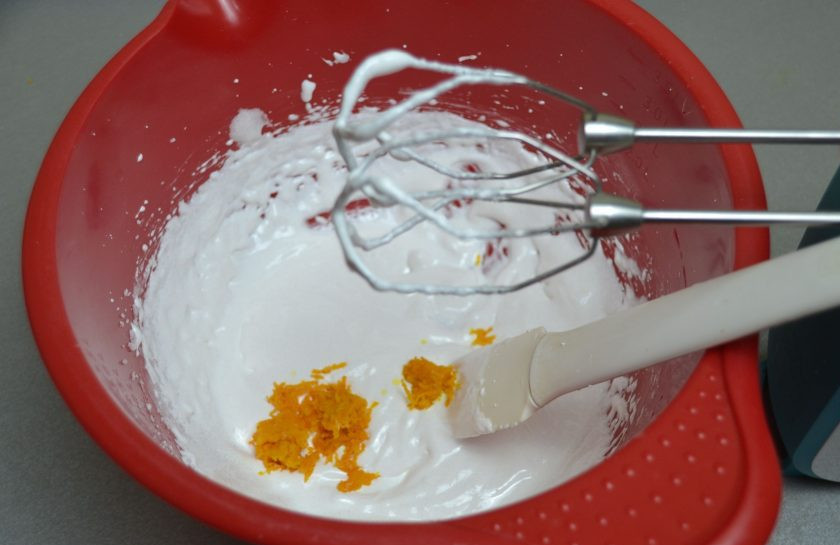 1. Этап. Апельсиновый зефир: Взбивайте яичный белок с сахаром до стойких пиков, добавьте апельсиновую цедру и снова взбейте.