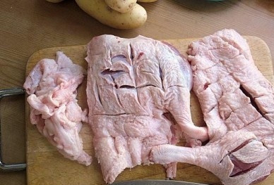 1. Этап. Утка, тушенная с картошкой в казане: Моем и разделываем утку. Если компания большая, можно использовать всю утку. Если нет, лучше тушить мясистые части этой птицы. Срезаем с утки жир, а на крупных кусках утки делаем небольшие насечки, прорезаем кожу, чтобы при жарке вытапливался оставшийся жир.