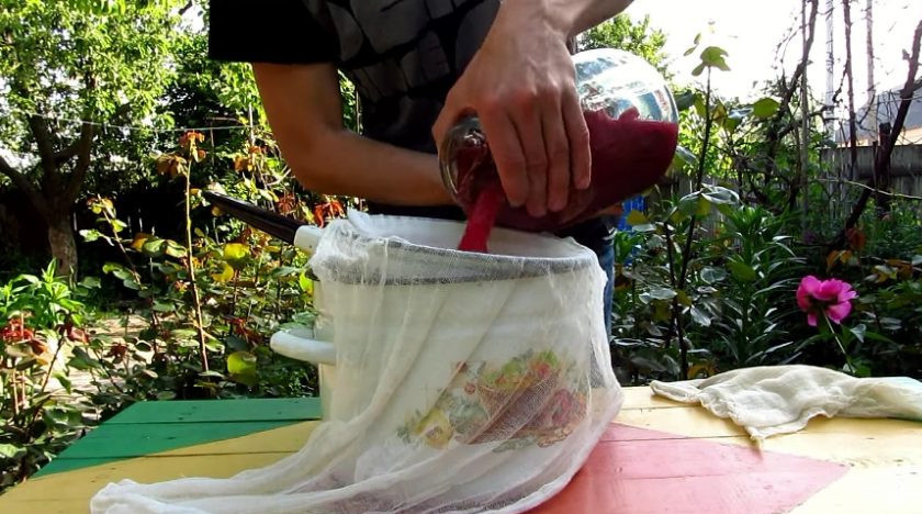 1. Этап. Квас из красной свеклы: Через три дня квас нужно процедить. Для этого в кастрюлю поставьте дуршлаг, на него положите марлю и вылейте все содержимое банки. Скрутите марлю и отожмите свеклу.