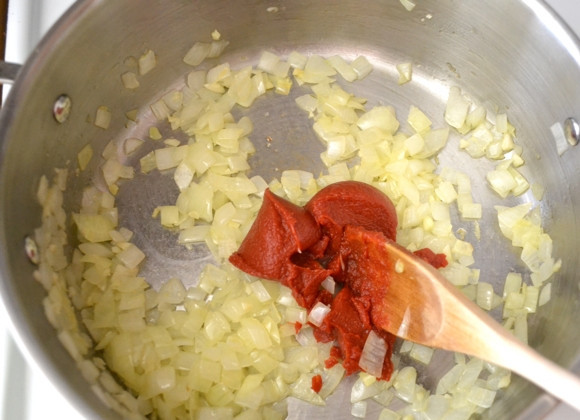 1. Этап. Тушеные овощи с чечевицей: 2. Как только лук станет мягким, добавьте в кастрюлю томатную пасту.