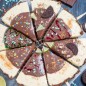Лаймовый тарт-мороженое Расчет продуктов дан на форму 20-23 см. Пачку шоколадного печенья Орео* и пачку Юбилейного поломать на кусочки, положить в комбайн, всыпать ложку сахара и измельчить в крошку. *Вместо указанных марок печенья можно взять любое сладкое печенье. Влить растопленное масло и перемешать в пульсовом режиме 3-5 раз. Силиконовую или разъемную форму смазать сливочным маслом и распределить крошку по дну и стенкам, утрамбовать. Выпекать при Т 180С 3-5 минут, до зарумянивания. Снять цедру с лаймов, выжать сок. В сгущенное молоко добавить яичные желтки и взбить миксером с насадкой венчик в течение 5 минут, масса посветлеет и станет более воздушной. Влить лаймовый сок и снова взбить. Добавить цедру, перемешать. На шоколадную основу вылить лаймовый крем, запечь в духовке при Т180С 10 минут, охладить и убрать в морозилку на 24 часа (если уверены в качестве яиц, крем можно не подвергать термической обработке, а заморозить сразу). Для декора приготовить все заранее, чтобы крем не потек, а шоколад не успел застыть на ледяном десерте - посыпки кондитерские, цветной гель, измельченные орехи, карамельную крошку, дольки лайма, кусочки шоколадного печенья и т. д. Для шоколадного ганаша - нагреть сливки до кипения и залить ими шоколад, поломанный на маленькие кусочки. Перемешать, охладить. Тарт извлечь из формы, горячим сухим ножом разрезать на сегменты, со стороны печенья тонким острым ножом проколоть дырочки, вставить палочки от мороженого, полить шоколадным ганашем, украсить как подсказывает фантазия. Хранить в морозилке до подачи.
