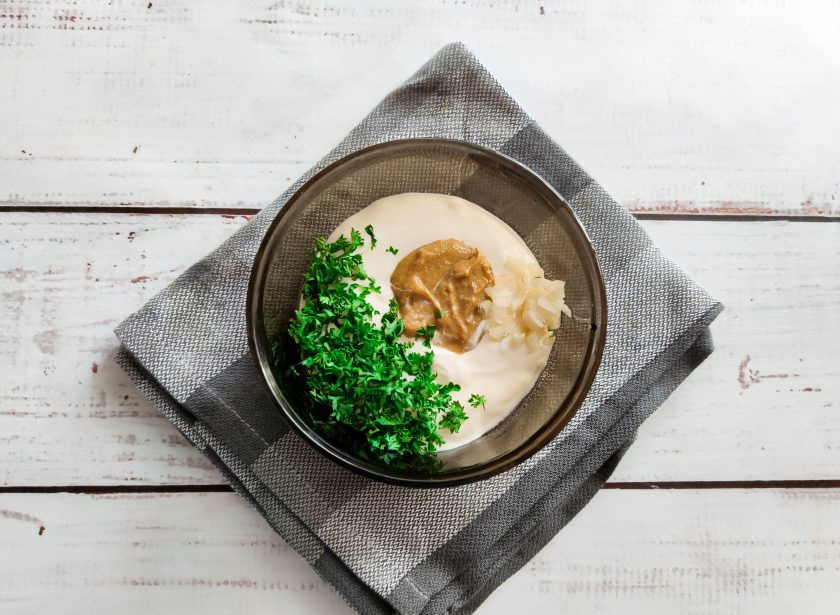 1. Этап. Салат Паради: В отдельной емкости соедините сметану, горчицу, соль, мелко нарезанную зелень, чеснок и хорошо все перемешайте.