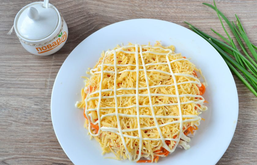 1. Этап. Салат Солнышко на Пасху: Твердый сыр натрите на терке и выложите следующим слоем. Также покройте майонезом.