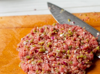 1. Этап. Тартар из телятины: Далее мы смешиваем все нарезанные ингредиенты, добавляем к ним оливковое масло, горчицу, два перепелиных яйца и смесь перцев. Хорошенько все перемешиваем и еще рез измельчаем ножом, солим массу по вкусу.