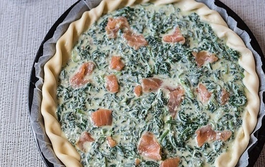 1. Этап. Закусочный пирог со шпинатом и семгой: 5. Смесь со шпинатом выложите на рыбу, разровняйте, добавьте сверху еще кусочки семги и разложите кусочки сливочного масла.