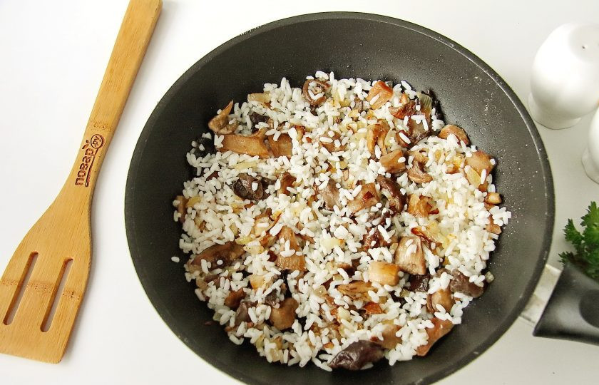 1. Этап. Фаршированные кальмары Мышки: Добавьте отваренный рис, перемешайте, прогрейте пару минут, после чего снимите с огня и дайте содержимому немного остыть.