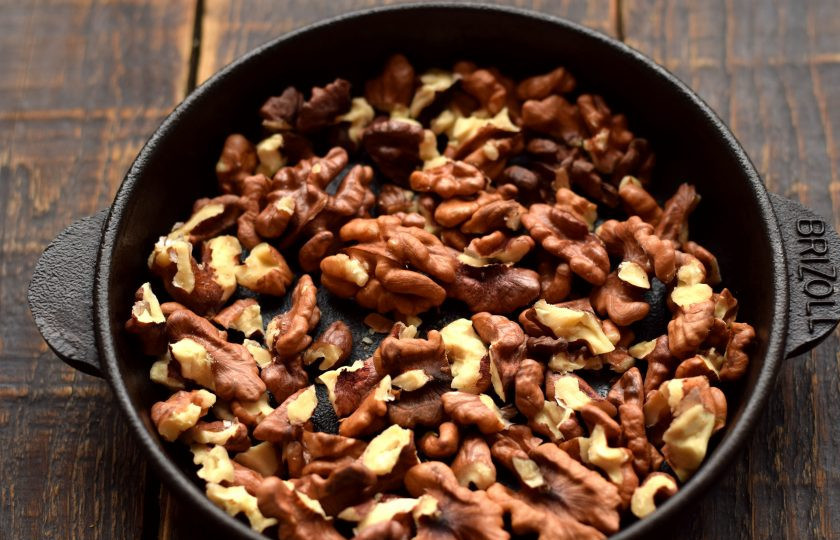 1. Этап. Чернослив с грецким орехом в сливках: Грецкий орех очистите от скорлупы и перепонок, разрежьте его на 4 части. Орехи слегка подсушите на сухой сковороде.