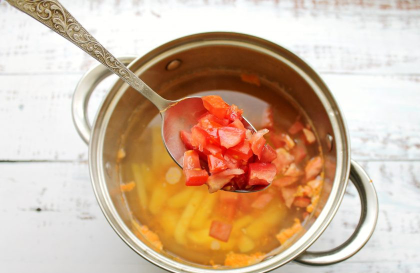 1. Этап. Дачный рисовый суп со снытью: Помидоры порежьте кубиком и добавьте в суп. Варите все в течение 5 минут.