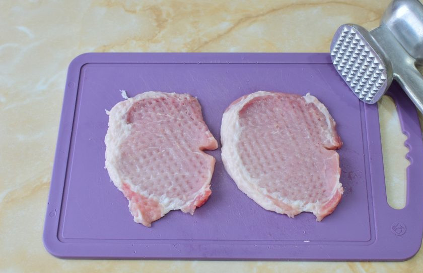 1. Этап. Свинина с кедровыми орешками: Мясо нарежьте порционными кусочками и немного отбейте кухонным молоточком. Можно оставить небольшое количество жира, он придаст сочность при жарке.