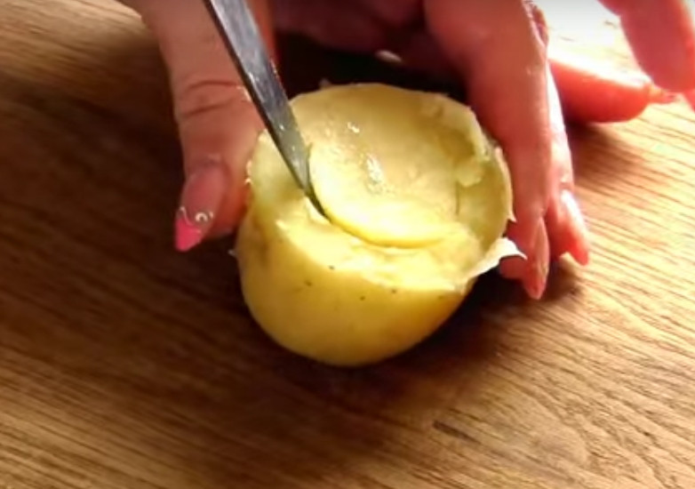 1. Этап. Картошка, фаршированная перепелиными яйцами: 2. Разрежьте отварной картофель на 2 половины и срежьте низ у каждой половинки. Ложкой сделайте углубление.