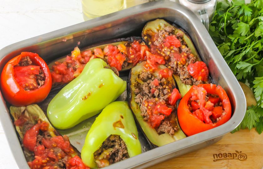 1. Этап. Бадымджан: Измельчите извлеченную мякоть помидоров и выложите на овощи в форме. Разогрейте духовку и поместите в нее форму с овощами.